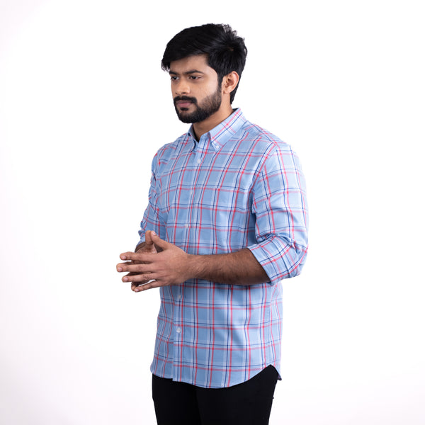 Man wearing a blue checkered shirt on a white background